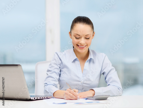 Photo: businesswoman working with documents in office businesswoman working with documents in office