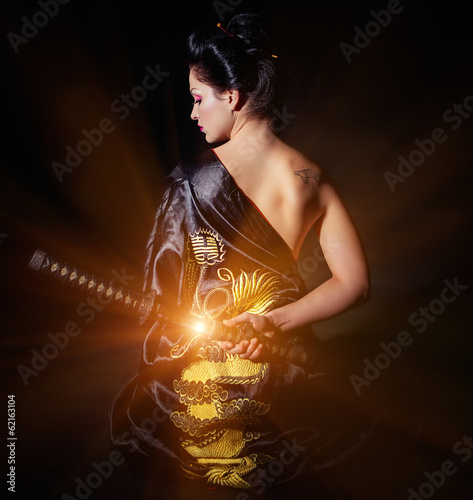 Photo: Woman with japan sword katana in hands Woman with japan sword katana in hands