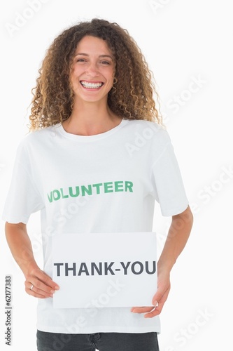 Photo: Smiling volunteer showing a thank you poster Smiling volunteer showing a thank you poster
