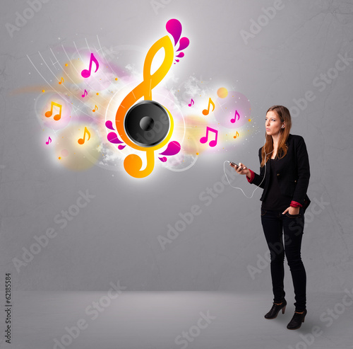 Photo: pretty girl singing and listening to music with musical notes pretty girl singing and listening to music with musical notes