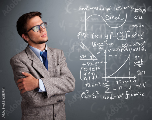 Photo: Handsome school boy thinking about complex mathematical signs Handsome school boy thinking about complex mathematical signs