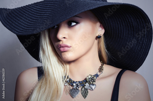 Photo: Beautiful Blond Woman in Black Hat.Beauty Girl. Spring Jewelry Beautiful Blond Woman in Black Hat.Beauty Girl. Spring Jewelry