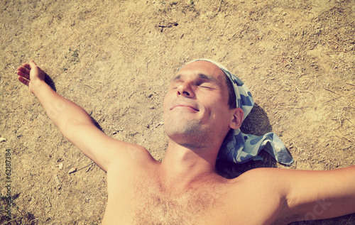 Photo: man sunbathes on the sun man sunbathes on the sun