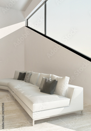 Photo: White couch in front of angular window White couch in front of angular window