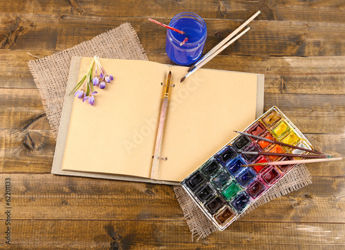 Photo: Composition with colorful watercolors, brushes and sketcher Composition with colorful watercolors, brushes and sketcher