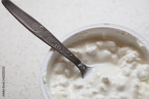 Photo: Cottage cheese and teaspoon. Diet and healthy nutrition. Cottage cheese and teaspoon. Diet and healthy nutrition.