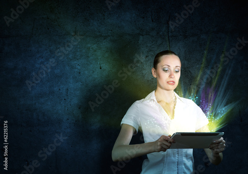Photo: young attractive woman holding a tablet young attractive woman holding a tablet