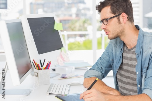 Photo: Casual male photo editor using graphics tablet Casual male photo editor using graphics tablet