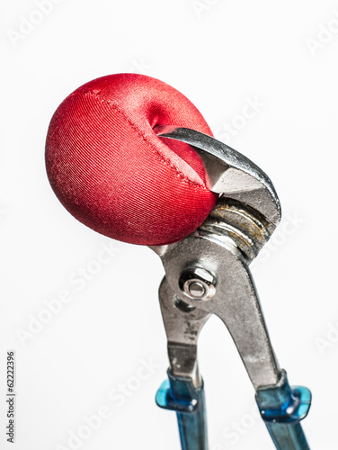 Photo: Wrench squeezing red stress ball Wrench squeezing red stress ball