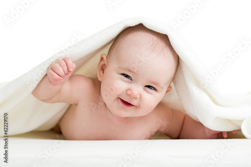 Photo: Adorable happy baby in towel Adorable happy baby in towel