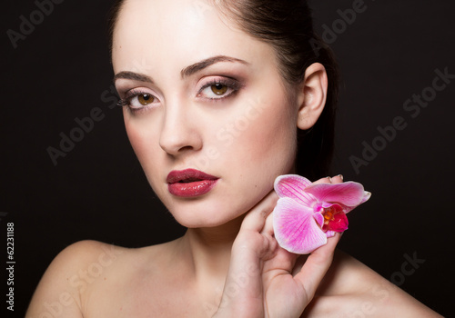 Photo: Beautiful woman with orchid Beautiful woman with orchid