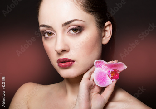 Photo: Beautiful woman with orchid Beautiful woman with orchid