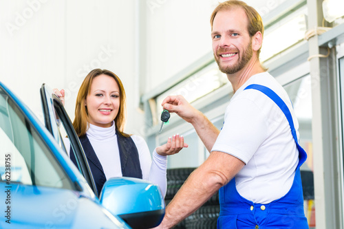 Photo: Kundin und Mechaniker an Auto in Werkstatt Kundin und Mechaniker an Auto in Werkstatt
