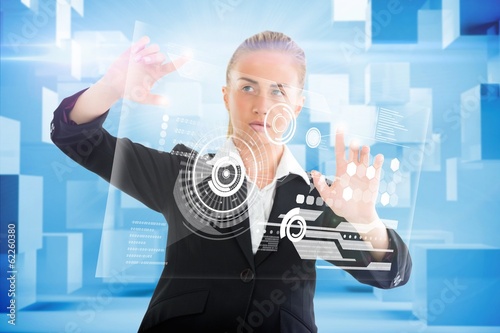 Photo: Blonde businesswoman touching interface Blonde businesswoman touching interface