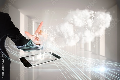 Photo: Finger pointing to clouds with tablet pc Finger pointing to clouds with tablet pc