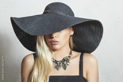 Photo: Beautiful Blond Woman in Black Hat.Spring.Accessories.Jewelry Beautiful Blond Woman in Black Hat.Spring.Accessories.Jewelry