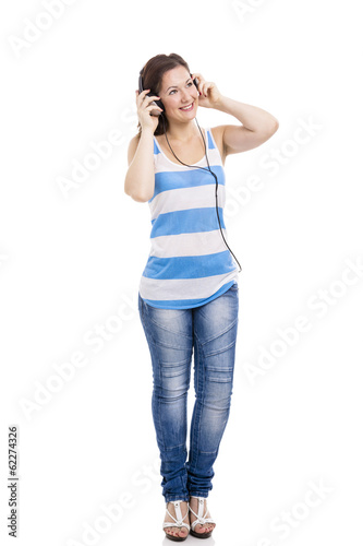 Photo: Beautiful young woman smiling and listen music Beautiful young woman smiling and listen music
