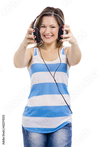 Photo: Beautiful young woman smiling and listen music Beautiful young woman smiling and listen music