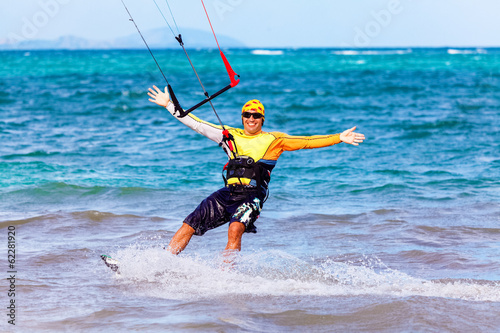 Photo: young smiling kitesurfer Extreme Sport Kitesur young smiling kitesurfer Extreme Sport Kitesur