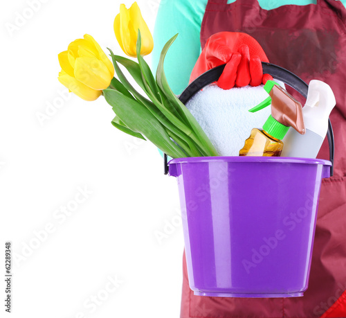 Photo: Housewife holding bucket with cleaning equipment. Conceptual Housewife holding bucket with cleaning equipment. Conceptual