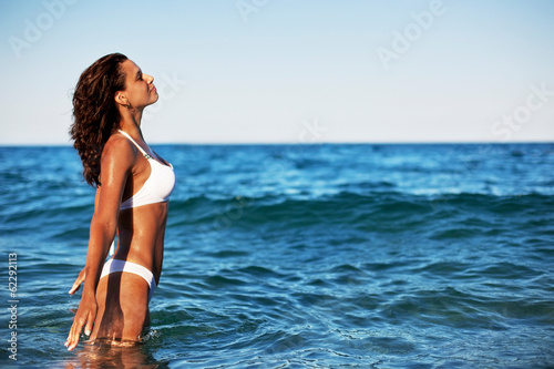 Photo: Young woman enjoying summer rest at the seaside. Young woman enjoying summer rest at the seaside.