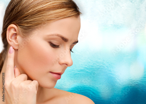 Photo: calm woman touching her ear calm woman touching her ear