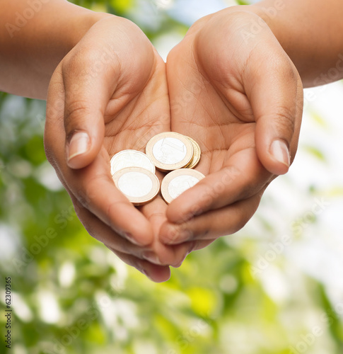 Photo: womans cupped hands showing euro coins womans cupped hands showing euro coins