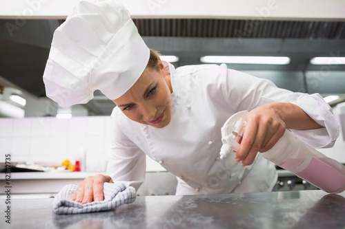 Photo: Chef wiping down surface and spraying detergents Chef wiping down surface and spraying detergents