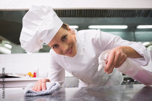 Photo: Chef wiping down surface and spraying detergents Chef wiping down surface and spraying detergents