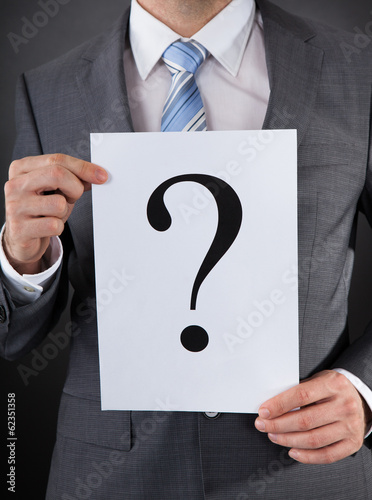 Photo: Businessperson With A Question Mark Sign Businessperson With A Question Mark Sign
