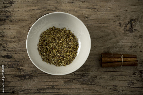 Photo: Dried elderberry and cinnamon on wooden table Dried elderberry and cinnamon on wooden table