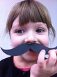 child with paper mustaches child with paper mustaches