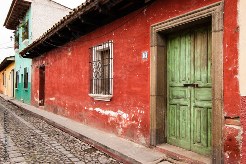 Photo: Colorful painted houses along cobbled street in Antigua Colorful painted houses along cobbled street in Antigua