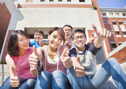 Photo: happy students thumbs up together happy students thumbs up together