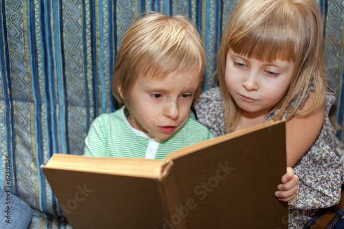 Photo: Boy and girl are reading book Boy and girl are reading book