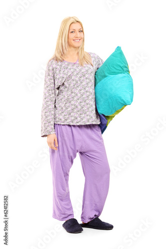 Photo: Blond girl in pajamas holding a pillow Blond girl in pajamas holding a pillow