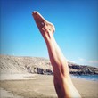 a man doing a yoga pose in the beach a man doing a yoga pose in the beach