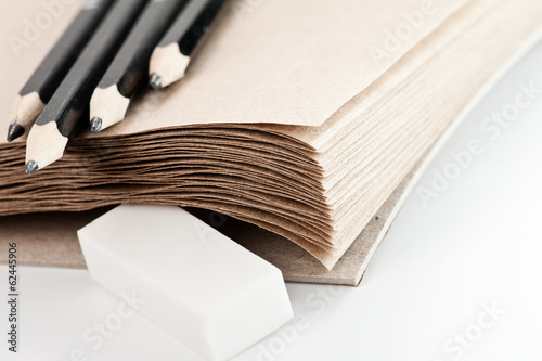 Photo: craft paper background with pencils and eraser craft paper background with pencils and eraser