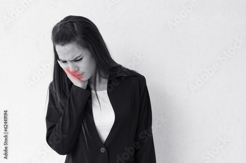 Photo: woman suffers from toothache, with red alert danger accent woman suffers from toothache, with red alert danger accent