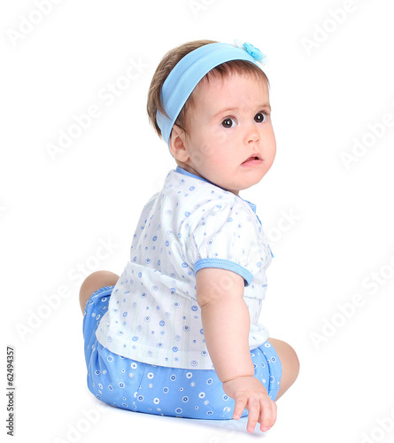 Photo: Cute baby girl sitting isolated on white Cute baby girl sitting isolated on white