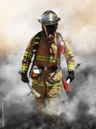 Photo: A firefighter pierces through a wall of smoke A firefighter pierces through a wall of smoke