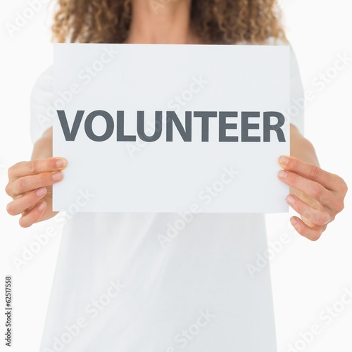 Photo: Volunteer showing a poster Volunteer showing a poster