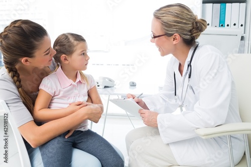 Photo: Mother and daughter visiting doctor Mother and daughter visiting doctor