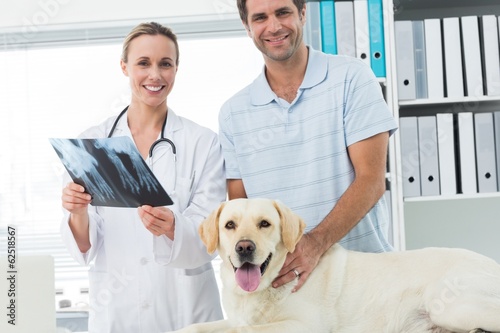 Photo: Pet owner and veterinarian with Xray of dog Pet owner and veterinarian with Xray of dog