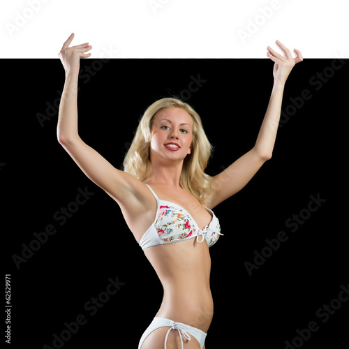 Photo: young attractive woman in bikini holding banner young attractive woman in bikini holding banner