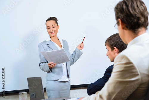 Photo: discusses business woman with colleagues discusses business woman with colleagues