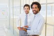 Two businessmen with digital tablet in office Two businessmen with digital tablet in office