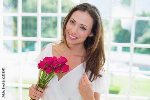 Photo: Beautiful woman with flowers at home Beautiful woman with flowers at home