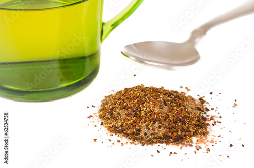 Photo: glass cup with fresh green tea leaves glass cup with fresh green tea leaves