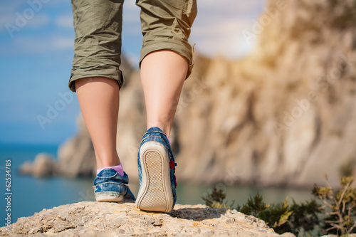 Photo: female feet in sneakers female feet in sneakers